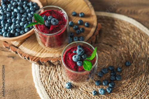 Fototapeta Naklejka Na Ścianę i Meble -  Fresh juicy blueberry smoothies in the glass. Simple background. Healthy food. Detox. Lifestyle