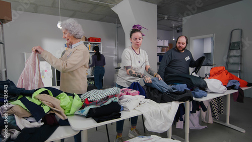 Volunteers sort second hand clothes for donation photo