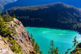 turquoise colored lake of Diablo Lake surrounded by towering mountains in North Cascade National Park in Washington.