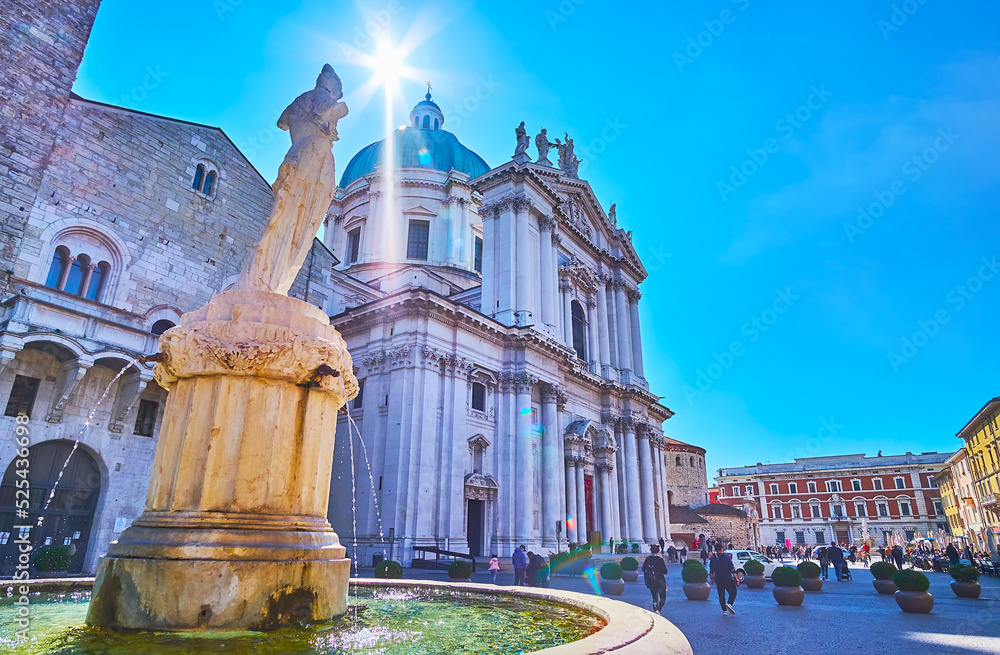 The sun over the ancient Minerva Fountain, Piazza del Duomo, Brescia, Italy
