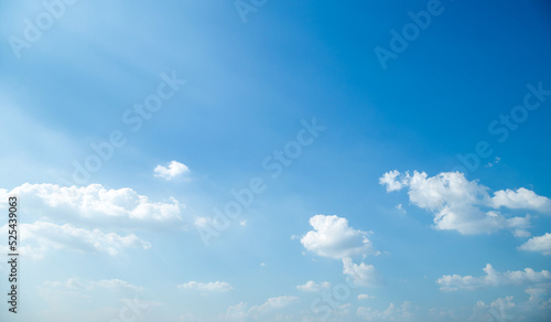 Blue sky with white, soft clouds, background