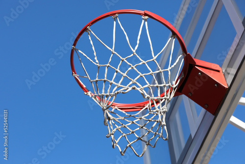 Basketball hoop with net outdoors on sunny day, low angle view © New Africa