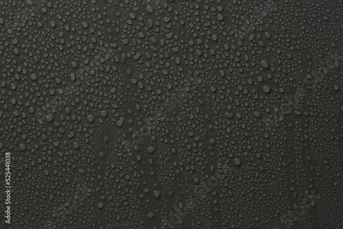 Many water drops on dark grey background