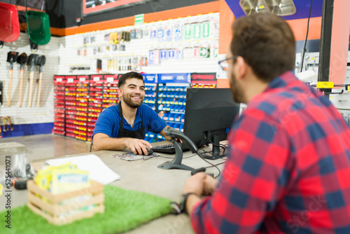 Hardware store worker looking cheerful while giving customer assistance