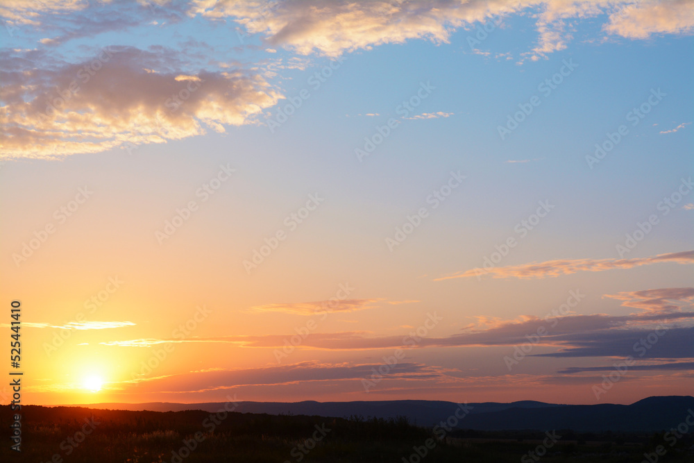 Picturesque view of landscape under beautiful evening sky with clouds at sunset