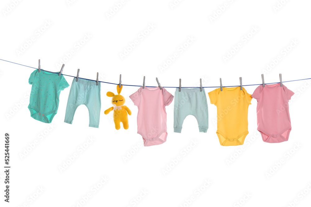 Colorful baby clothes and toy drying on laundry line against white background Colorful baby clothes and toy drying on laundry line against white background