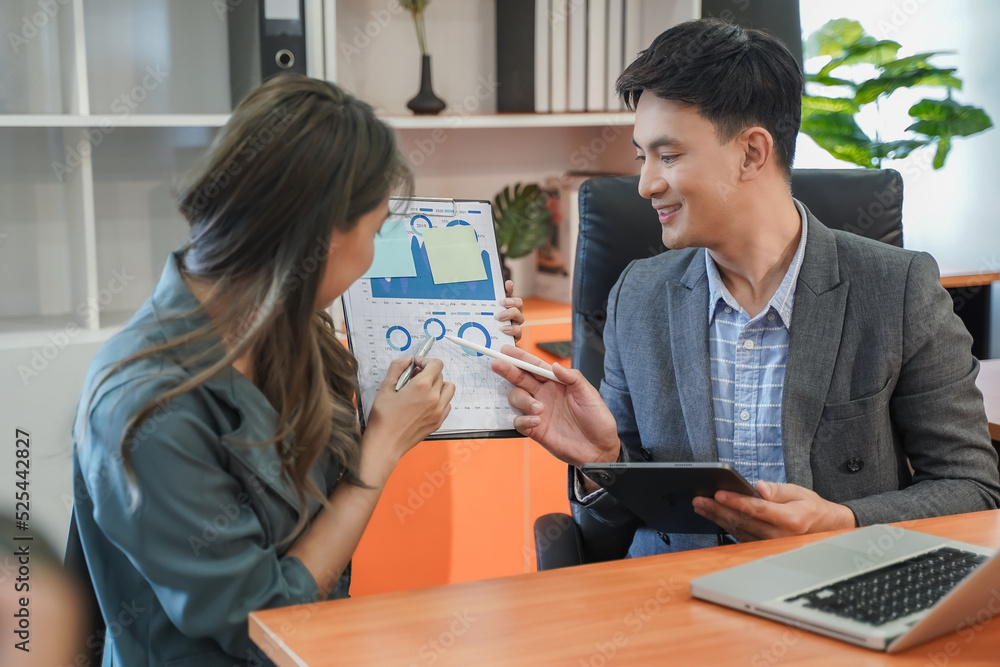 Obraz premium Happy businessman and businesswoman talk working team brainstorming idea on laptop and notebook job meeting communication plan project technology marketing strategy report