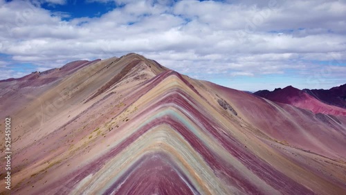 Drone shot of a rocky ridge with reddish ore on the rainbow mountain in Vinicunca photo
