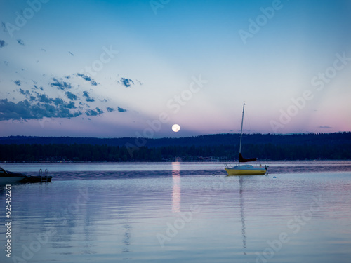 Sail Boat on a Lake with an Early Morning Moon