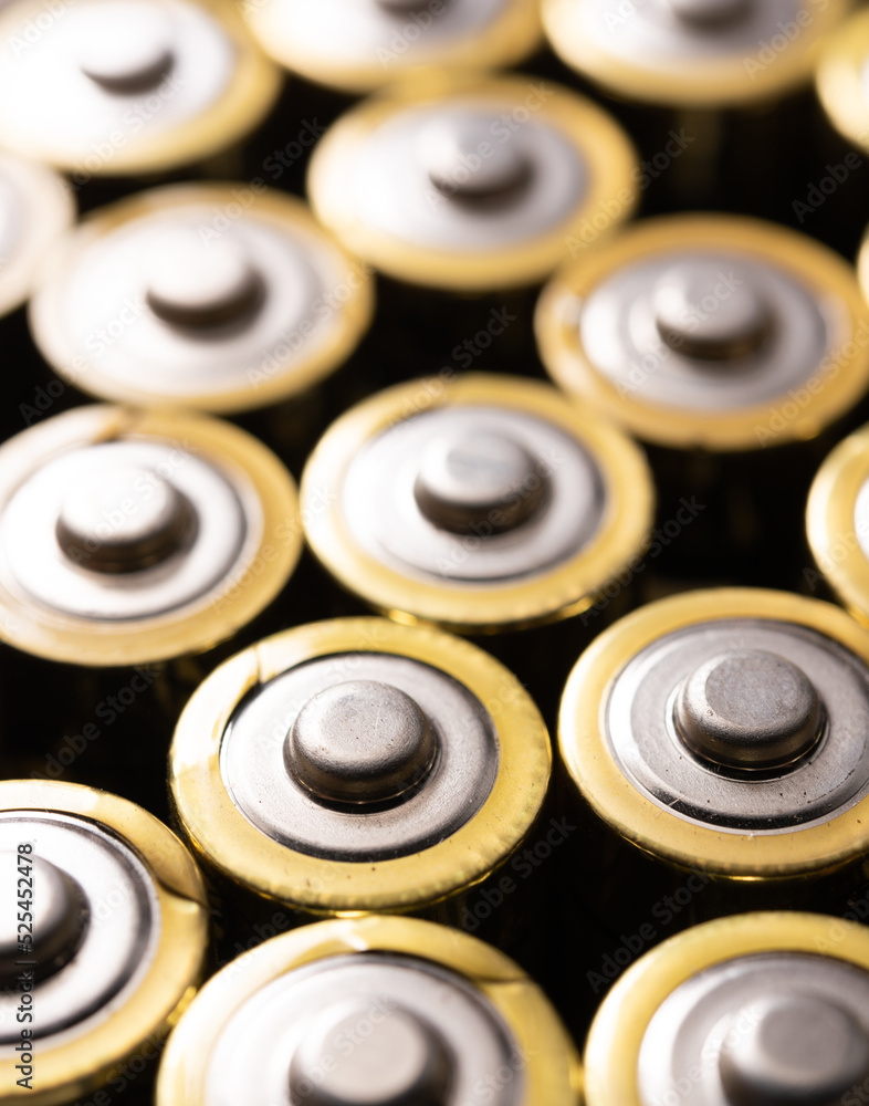 Closeup of positive ends of discharged batteries AA sizes, selective focus. Used alkaline battery. Hazardous garbage concept Closeup of positive ends of discharged batteries AA sizes, selective focus. Used alkaline battery. Hazardous garbage concept