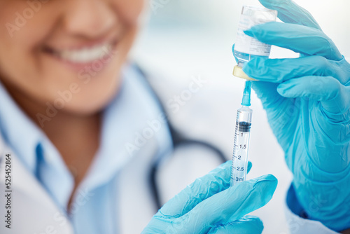 Doctor extracting medication from medicine vial with syringe in hospital or healthcare professional working at clinic. Vaccine treatment, or covid flu shot for sickness and medical nurse smiling. photo