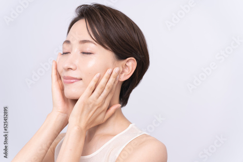 Skin care. Woman with beauty face touching healthy facial skin portrait. Asian woman. 