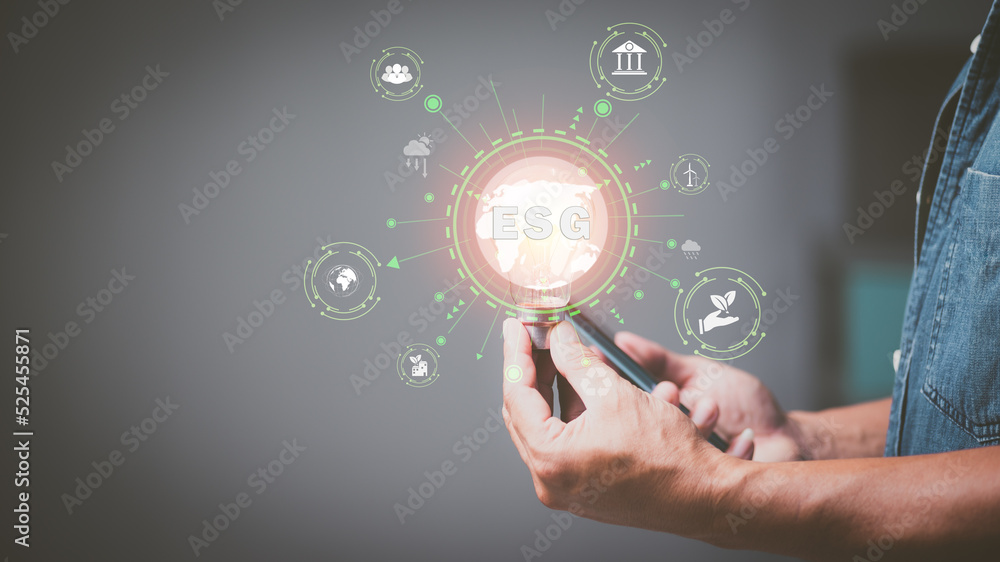 Environmental, social, and corporate governance,Ecology or eco friendly business,Global warming,Businessman holding a light bulb,ESG icon concept Environmental, social, and corporate governance,Ecology or eco friendly business,Global warming,Businessman holding a light bulb,ESG icon concept