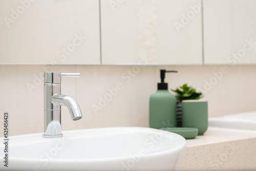 Clean shinning water tap faucet in modern bathroom.