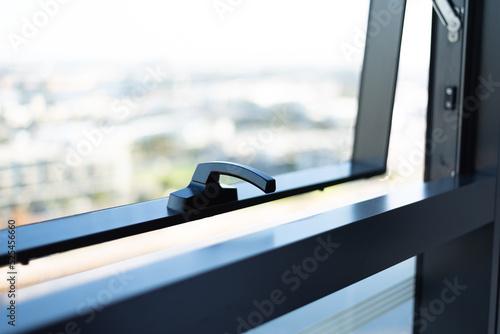 Slightly opened window with blurred view outside.