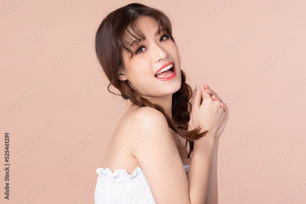 Naklejka premium Happy cheerful young asian woman with two pigtails natural beauty makeup, Fashion model, Health wellness, Beautiful girl skin care and facial treatment. Isolated on beige pink background.