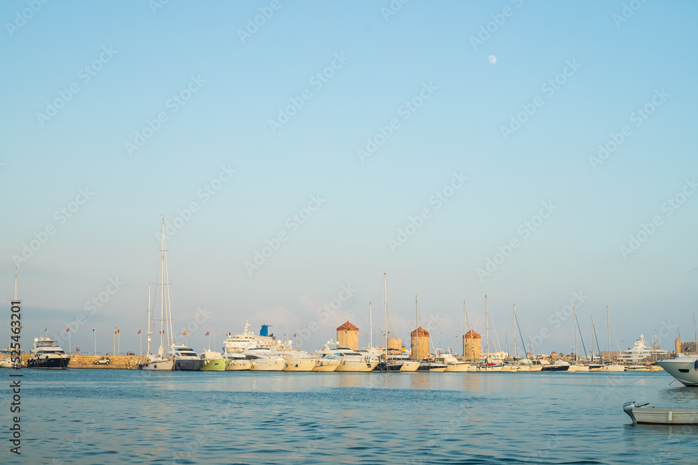 Fototapeta premium Fort of St. Nicholas in Mandaki Harbor, Rhodes, Greece.the famous deers, one of the island's symbols.Greece. View of famous tourist destination