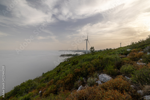 View of the mountain fog and wind turbines