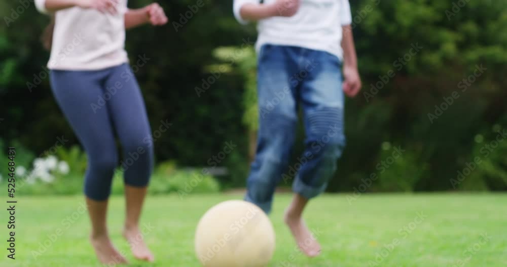 Family, fitness and kids playing football, exercise and fun at home with soccer ball in backyard. Siblings enjoying freedom and energy outdoors, bonding in childhood game and being active in garden Family, fitness and kids playing football, exercise and fun at home with soccer ball in backyard. Siblings enjoying freedom and energy outdoors, bonding in childhood game and being active in garden