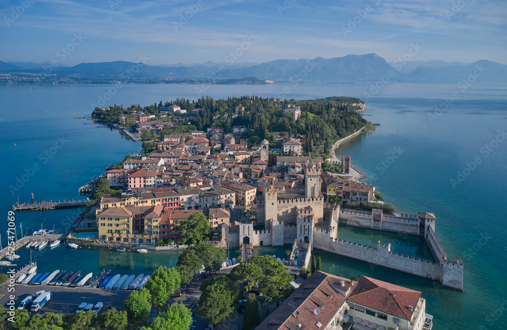Aerial view of Sirmione, an ancient village on southern Garda Lake. Sirmione top view. Popular travel destination on Lake Garda in Italy. Scaligero Castle drone view.