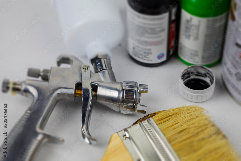paint spray gun at work at the workplace in the workshop. paint spray gun at work at the workplace in the workshop.