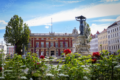 old post office in gorlitz and a fountain on a sunny day photo