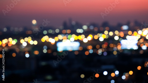 Blurred and  bokeh city aerial view from the rooftop view point image in the night © SASITHORN