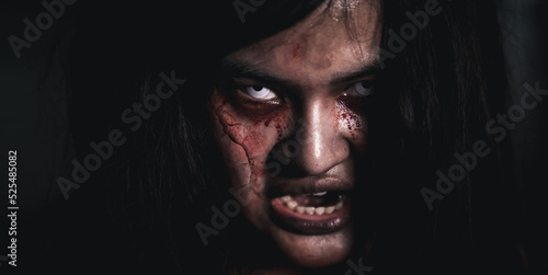 Фотография Horror bloodthirsty woman ghost or zombie she is horror scary with open mouth at