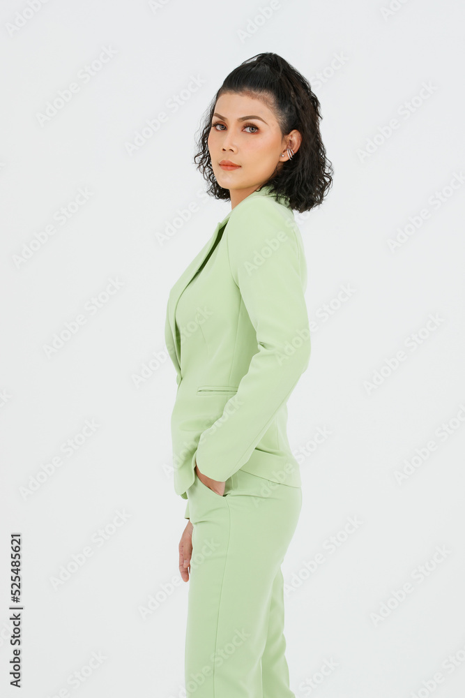 Portrait isolated studio full body shot of Asian young sexy curly hairstyle fashion model in green formal suit with black lace lingerie bra and high heels standing posing alone on white background Portrait isolated studio full body shot of Asian young sexy curly hairstyle fashion model in green formal suit with black lace lingerie bra and high heels standing posing alone on white background