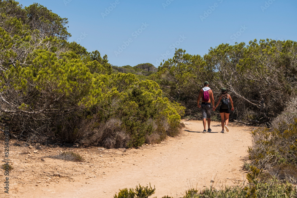 couple of tourists on the trail, s'Estalella, s Estanyol de Migjorn, Llucmajor, Majorca, Spain