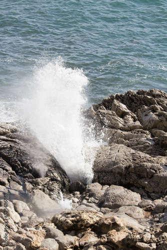 evocative image of a rough sea hitting the rocks in Sicily