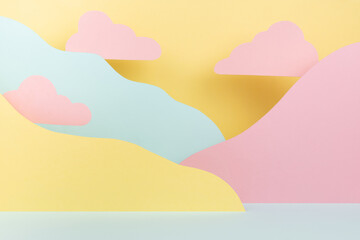 Abstract scene - landscape with pink clouds, mountains of paper in pastel yellow, mint color in funny cute children style. Creative background for design, presentation, poster, flyer, card, text.
