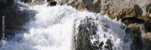 Rapid waterfall with foaming water in rocks background © megaflopp