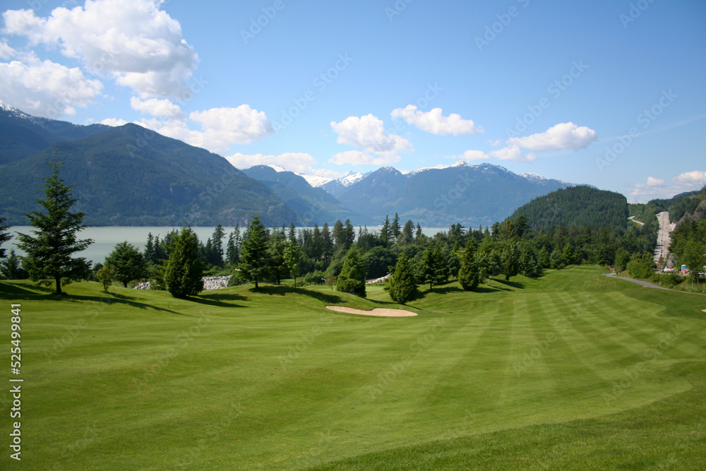 Golf course fairway with beautiful moutain scenery overlooking the Howe Sound in Squamish British Columbia Canada.