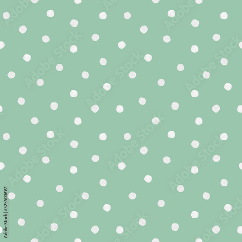 White roughly painted polka dot on mint green background. Seamless pattern. For wallpaper, textile, wrapping paper, packaging design and interior decoration