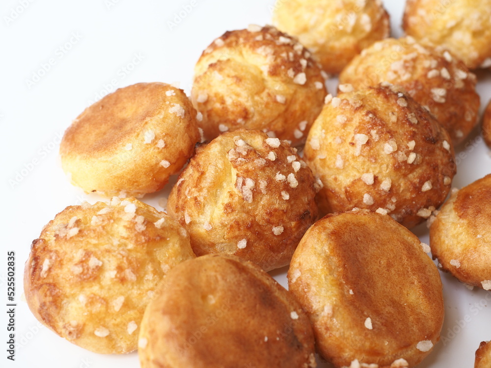 Chouquettes coated with sugar on white 