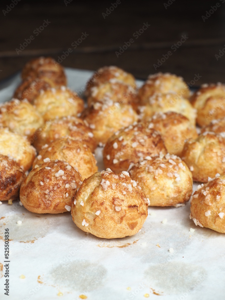 French Chouquettes coated with sugar on baking tray