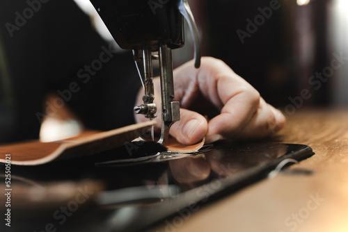 Man stitching textile in atelier photo