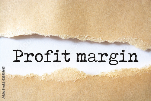 Profit Margin text on torn cardboard. Black letters on white paper