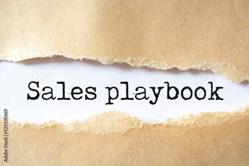 Sales playbook text on torn paper on the white background