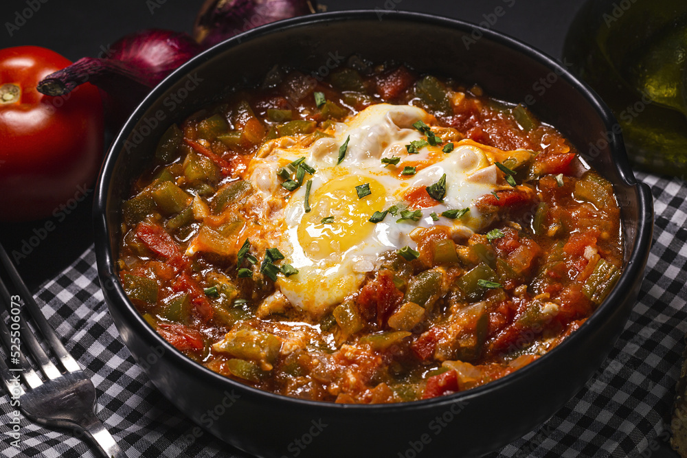 Tasty pisto with egg and vegetables in bowl Tasty pisto with egg and vegetables in bowl