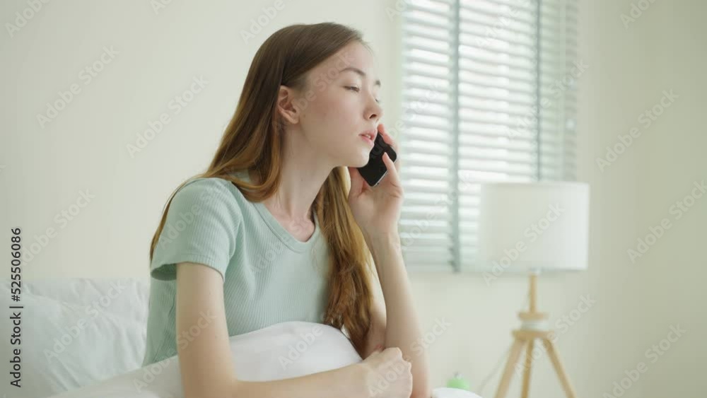 Frustrated Caucasian woman talking on mobile phone in bedroom at home. Frustrated Caucasian woman talking on mobile phone in bedroom at home.