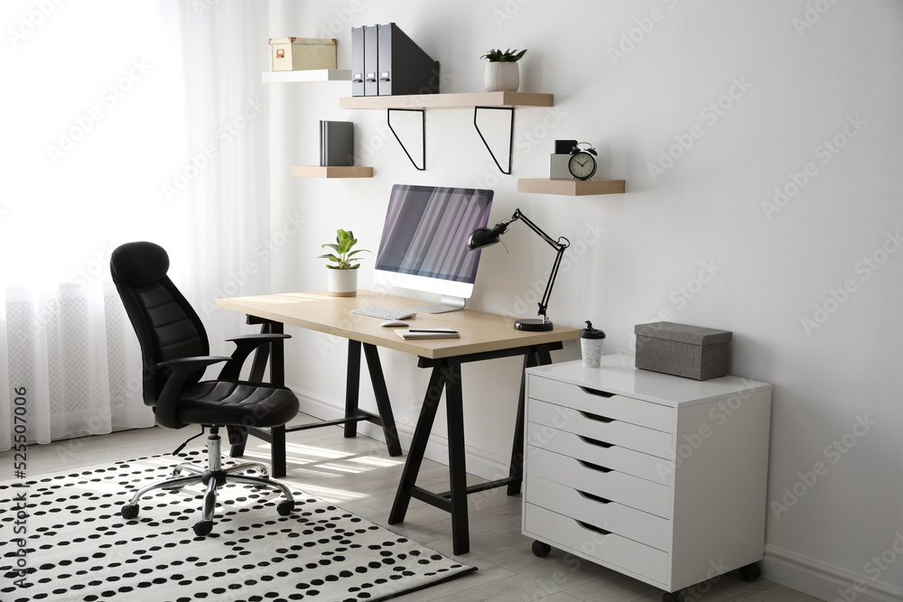 Comfortable office chair near table with modern computer Comfortable office chair near table with modern computer