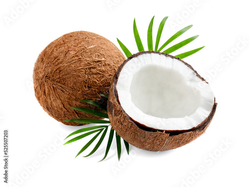 Fresh ripe coconuts with green leaves on white background