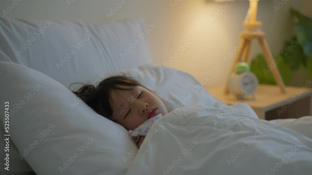 Asian adorable young kid daughter sleeping on bed in bedroom at home. Asian adorable young kid daughter sleeping on bed in bedroom at home.