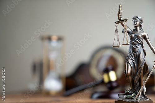 Law concept. Law symbols composition: judge’s gavel, Themis sculpture and scale on rustic wooden desk.