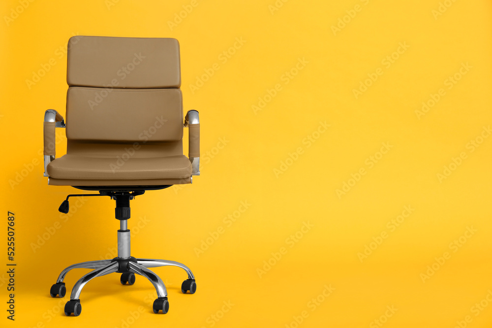 Modern office chair on yellow background. Space for text Modern office chair on yellow background. Space for text