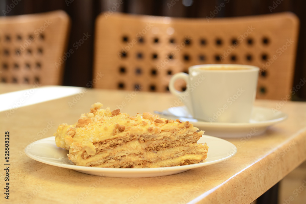 Piece of delicious cake and coffee on beige table, closeup Piece of delicious cake and coffee on beige table, closeup