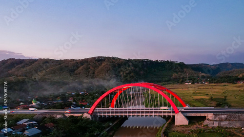 Aerial view of the Kalikuto Bridge, an Iconic Red Bridge at Trans Java Toll Road, Batang when sunrise. Central Java, Indonesia, August 24, 2022