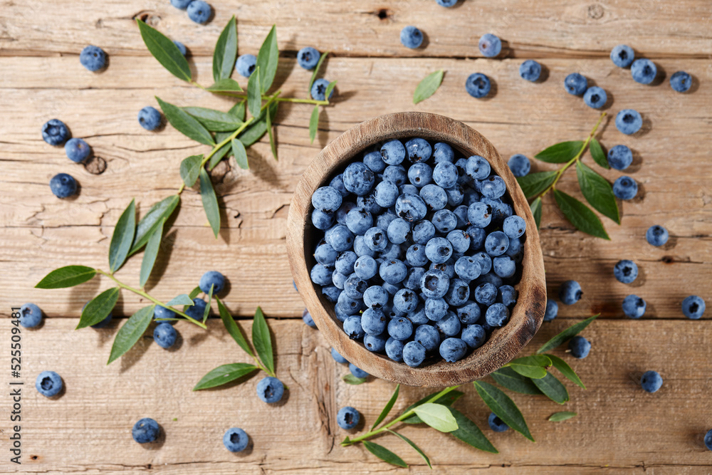 Fresh blueberries in bowl on wooden planks Fresh blueberries in bowl on wooden planks